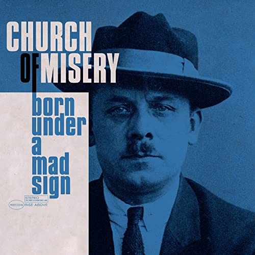 Blue-tinted portrait of a man in a fedora with album text overlaid.