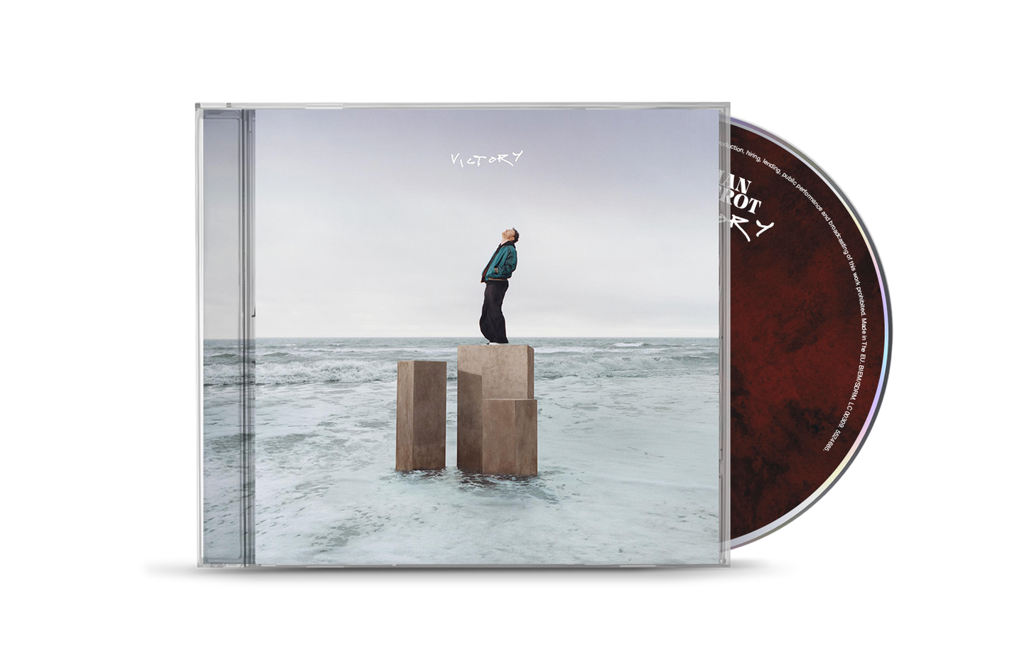 CD case for Cian Ducrot’s “Victory,” featuring a man on pillars by the sea.
