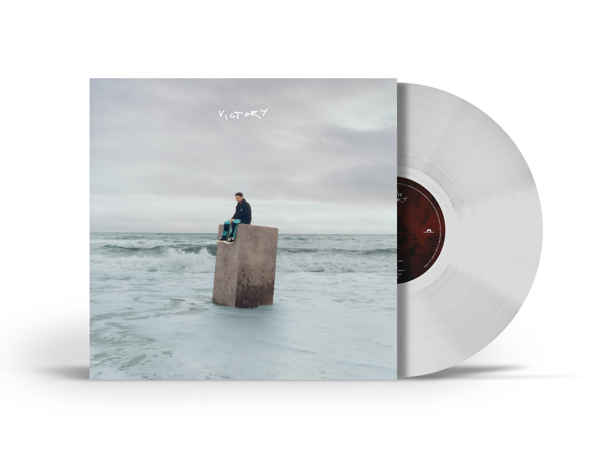 White vinyl record with cover art of a man on a concrete block.