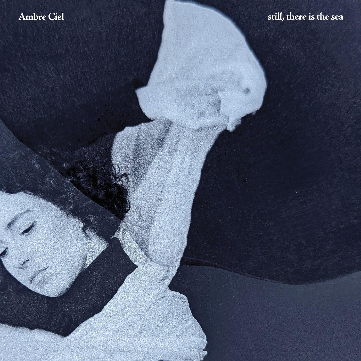 Album cover: person with eyes closed against a dark, textured background.