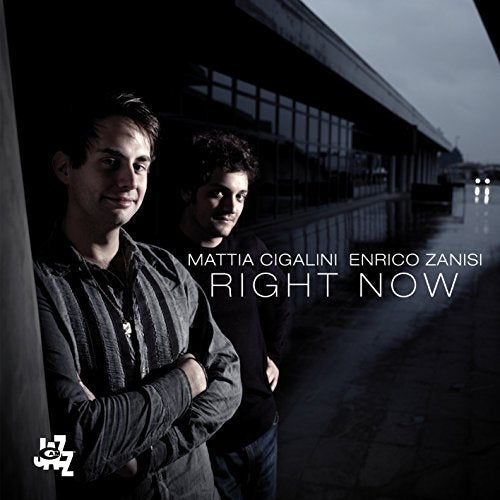 CD cover featuring two men against a blurred, modern building backdrop.