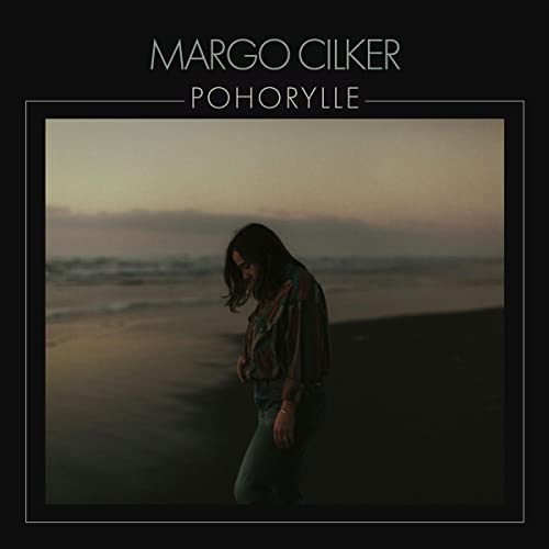 Album cover: woman on beach with muted, overcast sky.