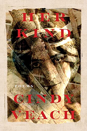 Book cover with a cat's face obscured by branches and red text.