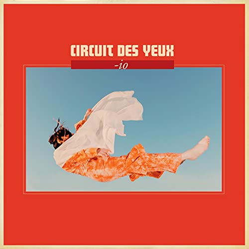 Album cover: woman in orange falling against a blue sky.