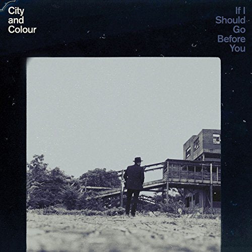 "Black vinyl record cover with a black-and-white photo of a man standing outdoors."
