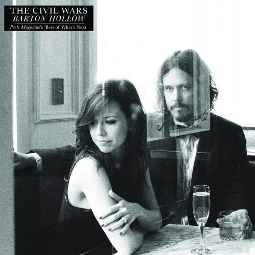 Black and white album cover featuring a man and woman indoors.