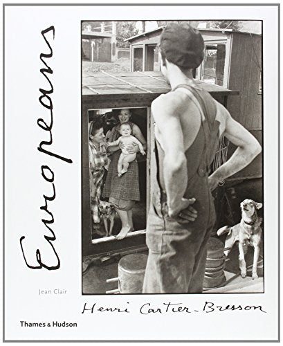 Black and white photograph of people and dogs reflected in a mirror.