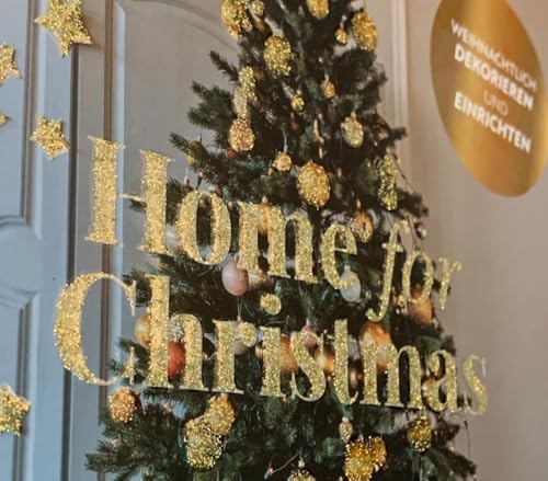 Gold glitter letters spell “Home for Christmas” on a decorated tree.