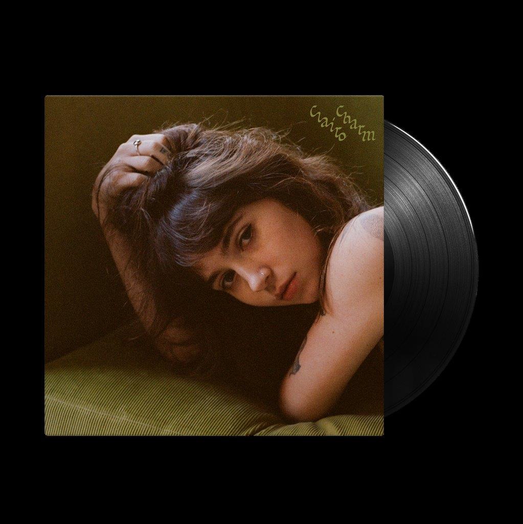 Clairo's "Charm" vinyl record with a portrait of the artist.
