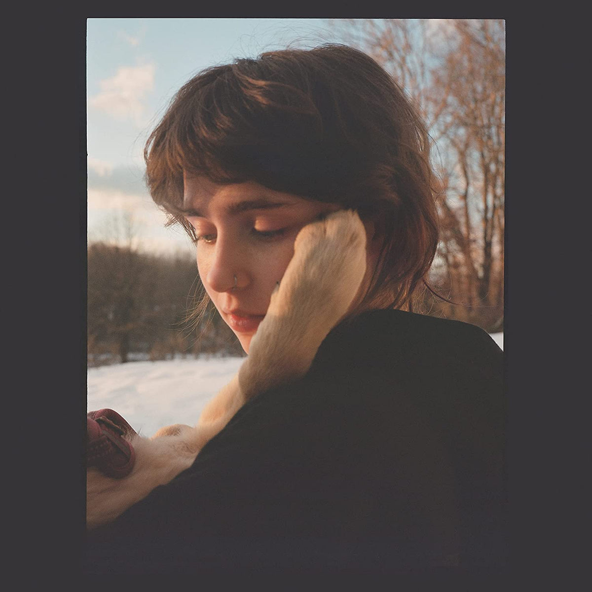 Clairo album cover, “Sling”, showing a young woman with her head in her arms.