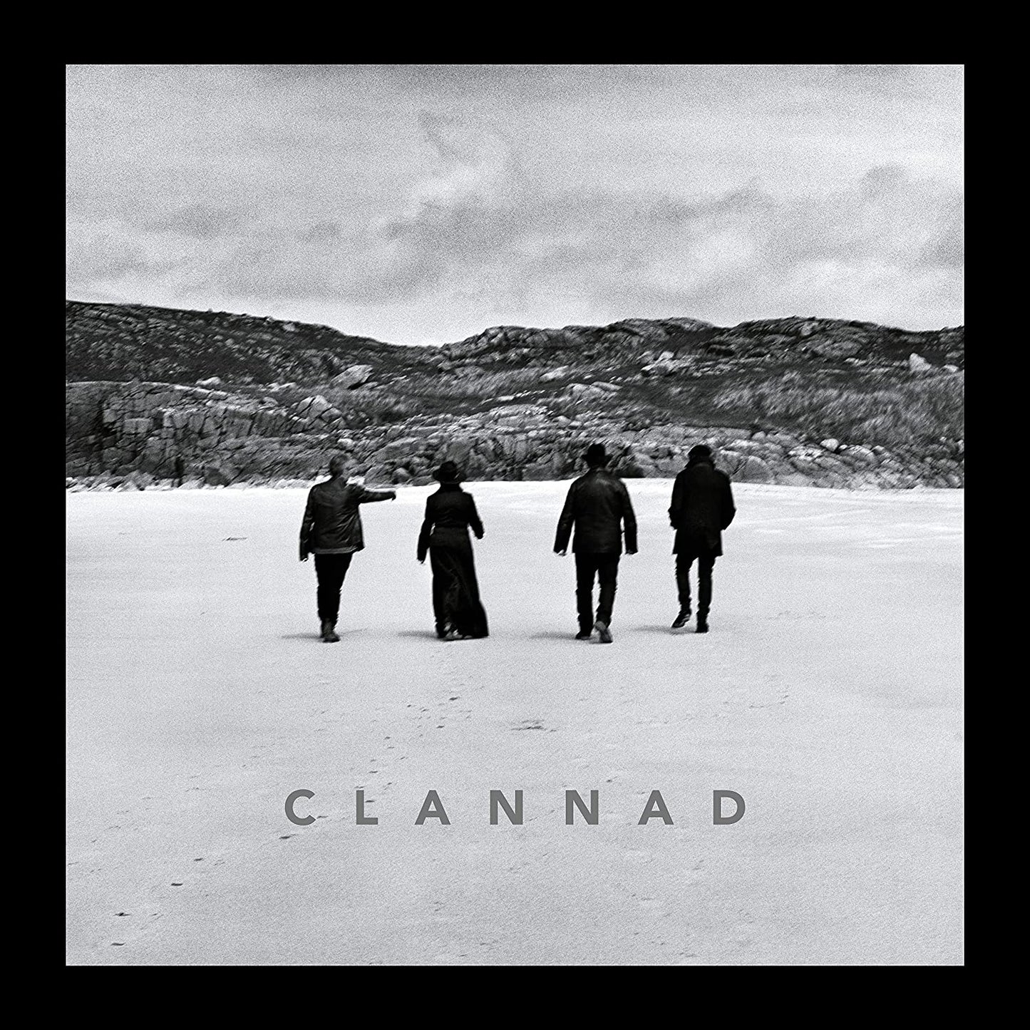 Black and white vinyl album cover featuring four people walking away on a frozen lake.