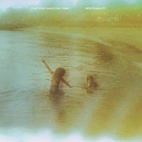 Album cover: two figures in water with a hazy, yellow-toned landscape.