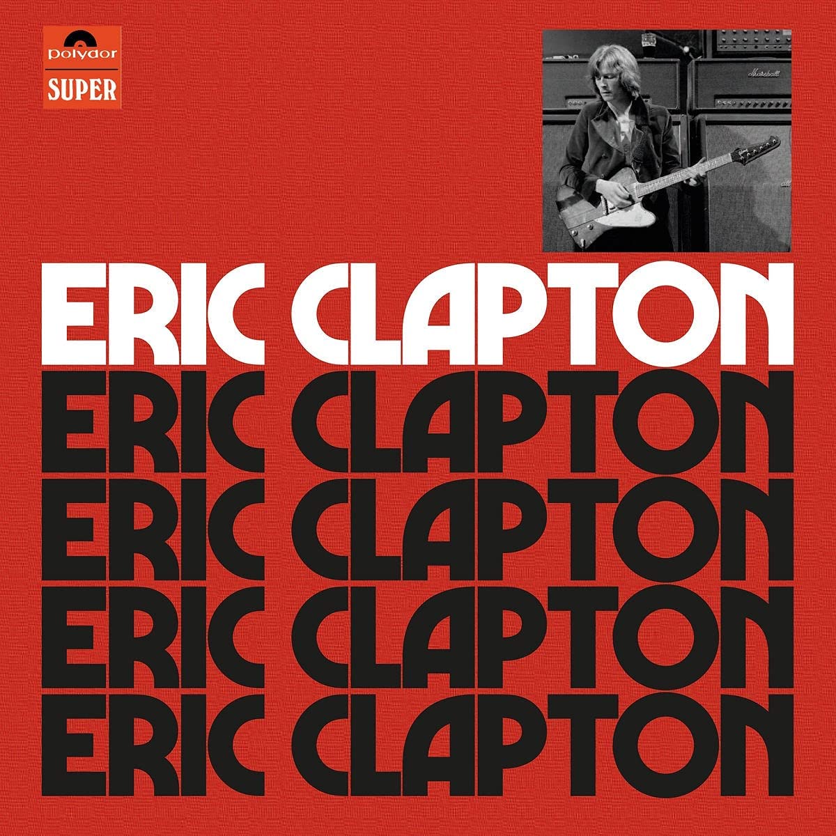 Red Eric Clapton anniversary CD box set with booklet and four discs.