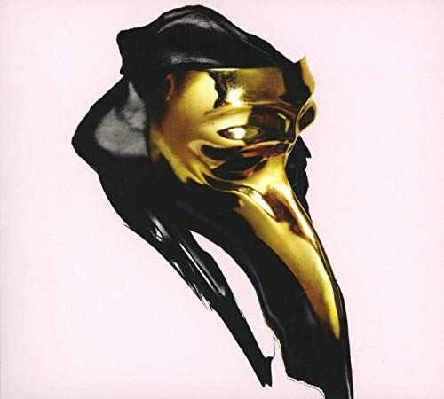 Golden plague doctor mask with black fabric against a pink background.