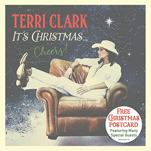 Terri Clark wearing a cowboy hat, sitting in a leather chair against snowy background.