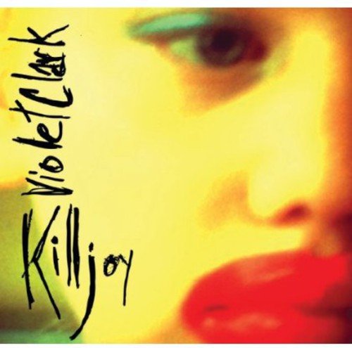 CD cover: close-up of a person’s eye and red lips, yellow background.