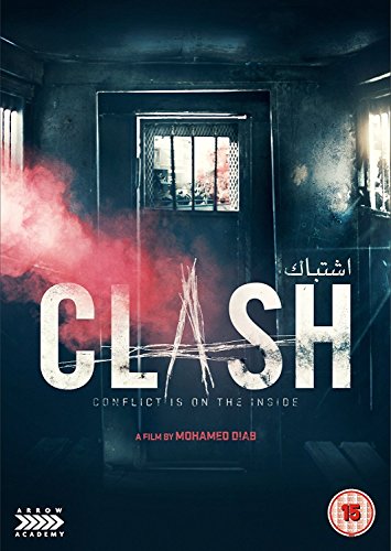 "Clash DVD cover featuring a dark room with red smoke and barred window."