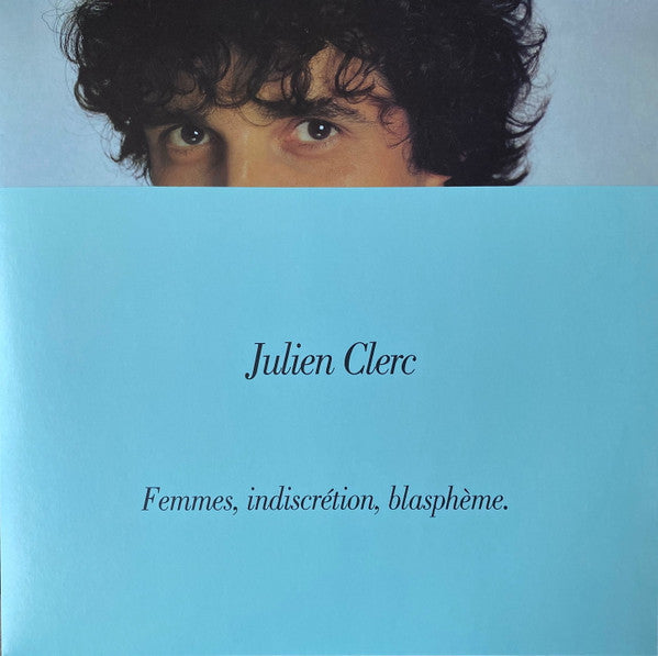 Julien Clerc's eyes visible above a light blue cover with his name and album title.