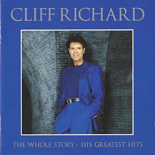 Cliff Richard wearing a blue suit against a brick background on an album cover.