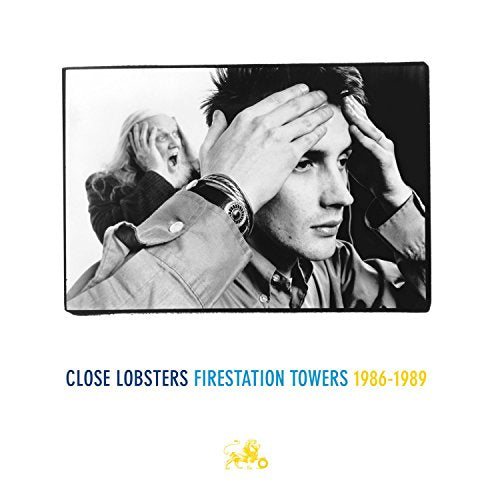 Black and white photo of a man and an older man holding their heads.