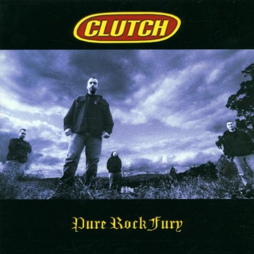 Clutch band members standing in a field under a stormy sky.