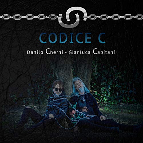 CD cover: two people bound by chains in front of a tree.