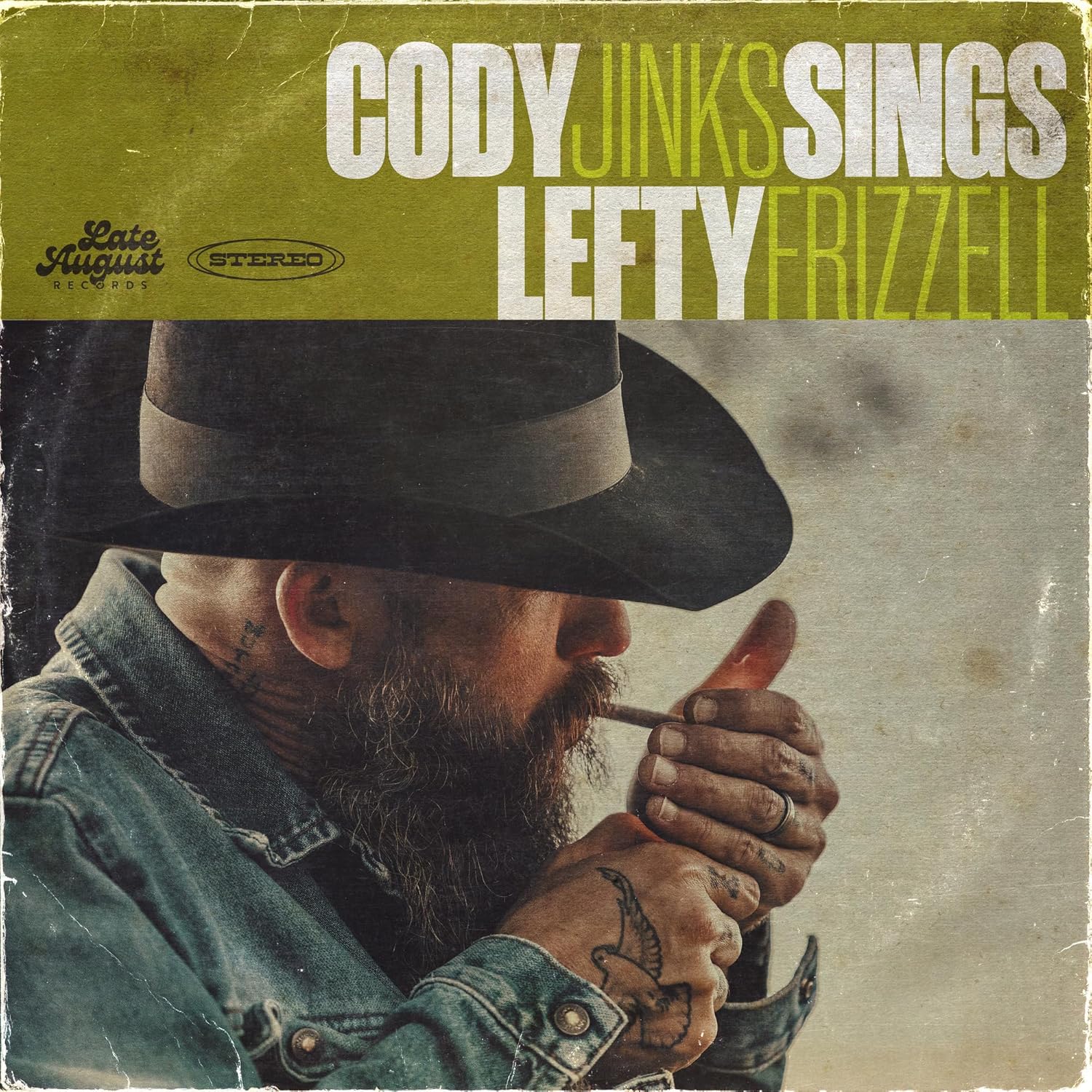 Vinyl album cover featuring a bearded man in a cowboy hat lighting a cigarette.