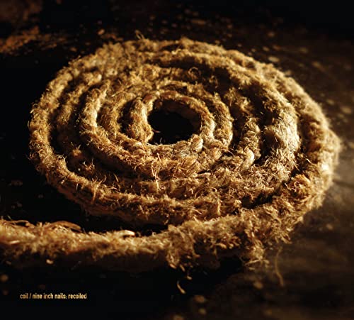 Spiral of rough, brown rope against a dark, textured background.