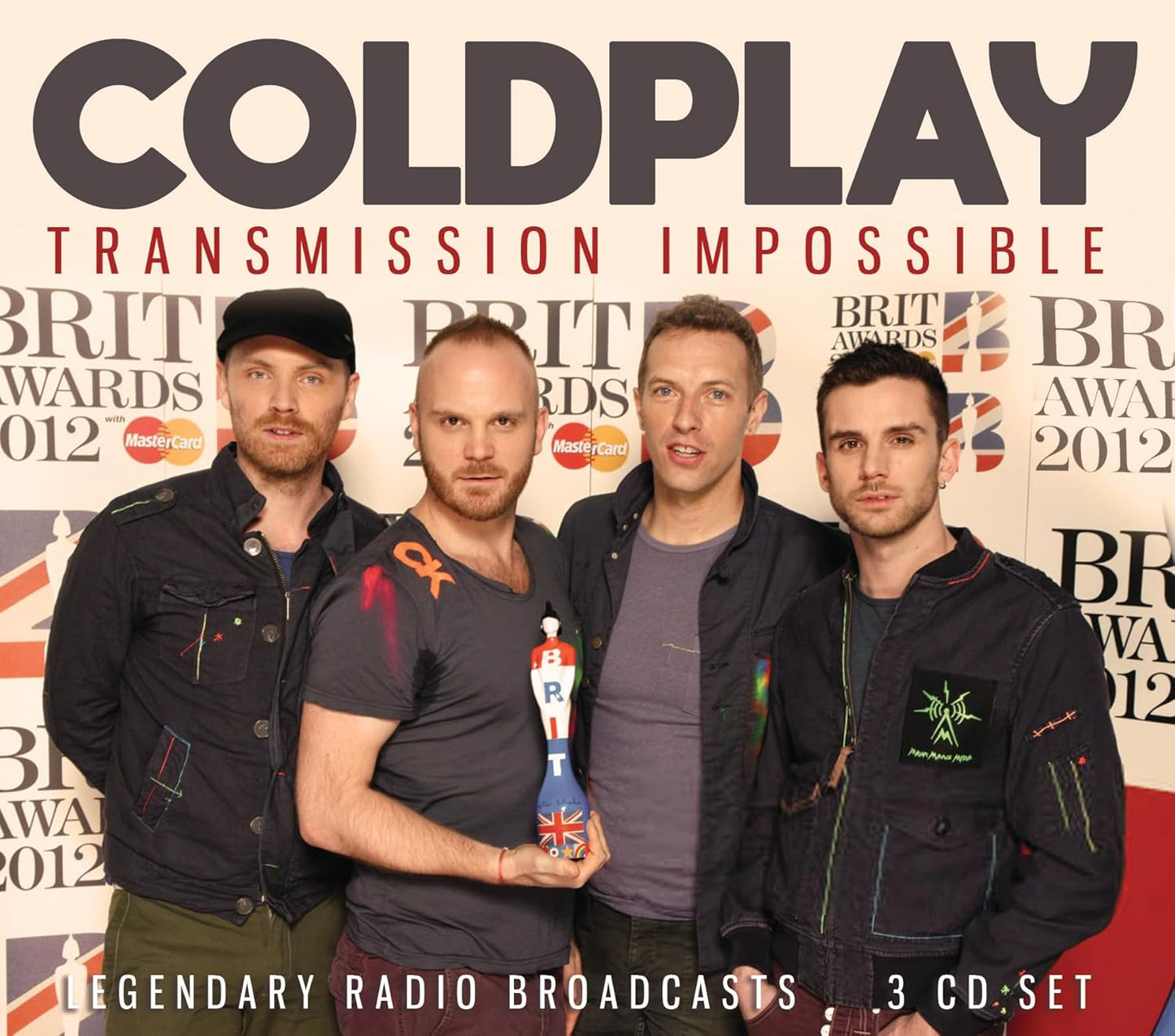 Coldplay band members posing in front of a 2012 Brit Awards backdrop.