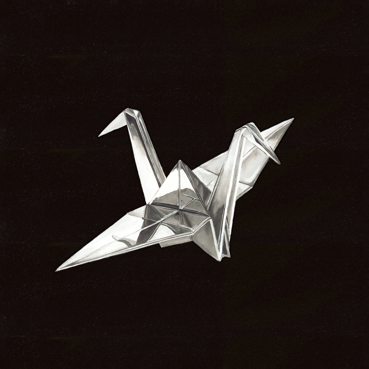 Silver origami crane against a black, speckled background.