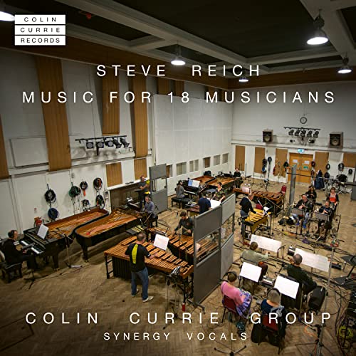 A high-angle view of a large ensemble performing in a recording studio.
