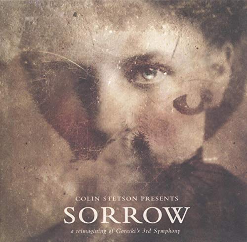 Close-up of a man’s face with the album title “SORROW” below.