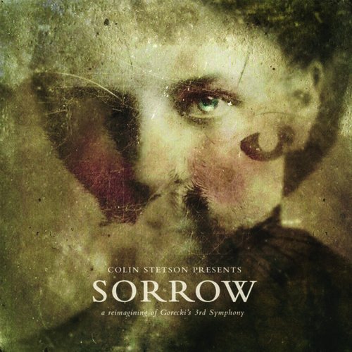 Vinyl album cover with a faded, sepia-toned portrait of a man's face.