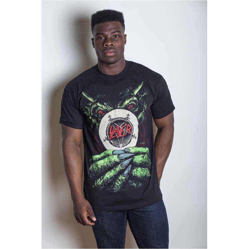 A man wearing a black Slayer t-shirt featuring a green demon holding a logo.