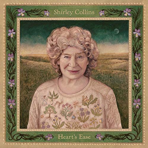 Portrait of Shirley Collins wearing an embroidered sweater, framed by a floral border.