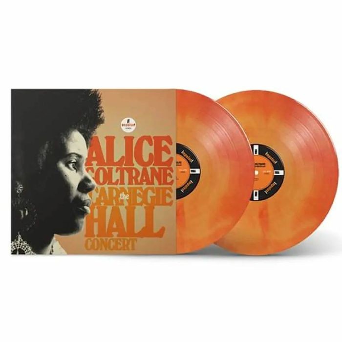 Alice Coltrane album cover and two orange vinyl records.