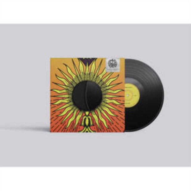 Vinyl record with orange and yellow sun-shaped album cover.