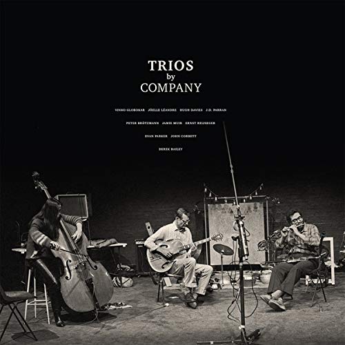 "Black and white album cover with three musicians playing instruments on stage."