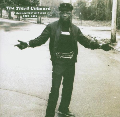 Black and white photo of a man in 80s hip-hop attire.