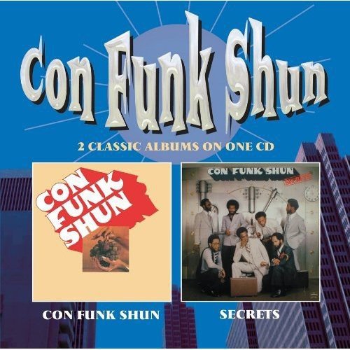 "CD cover with 'Con Funk Shun' title, featuring two album covers and cityscape background."
