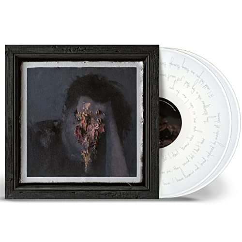 Vinyl record in black sleeve with abstract, dark portrait cover art.