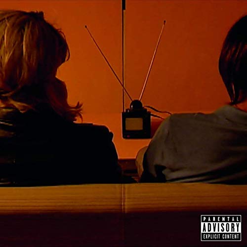The image is an orange-tinted album cover with two people and a radio device. For the alt text: "Album cover with two silhouetted people and a radio."