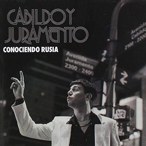 CD cover: black and white photo of a man with street background.