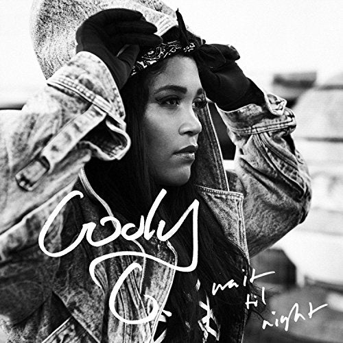 Black and white portrait of a woman wearing a denim jacket and bandana.