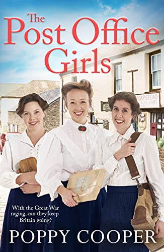 Three smiling women in wartime uniforms stand in front of a village.