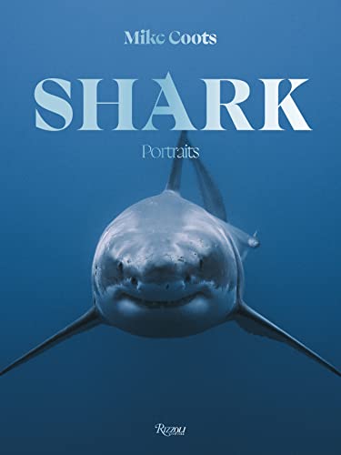 A great white shark swims toward the camera in deep blue water on book cover.