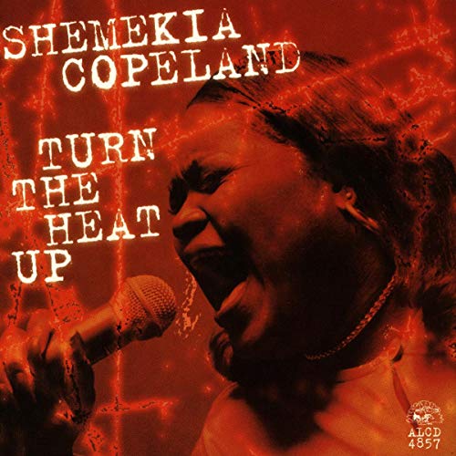 Shemekia Copeland singing into a microphone, album cover with red tones.