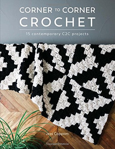 Crochet book cover featuring a black and white checkered blanket.