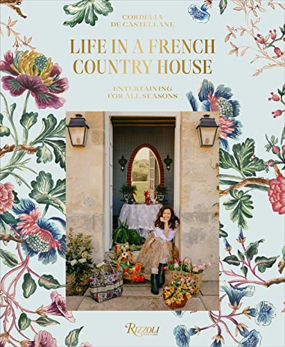 Book cover with floral border showing a woman sitting in a French country house doorway.