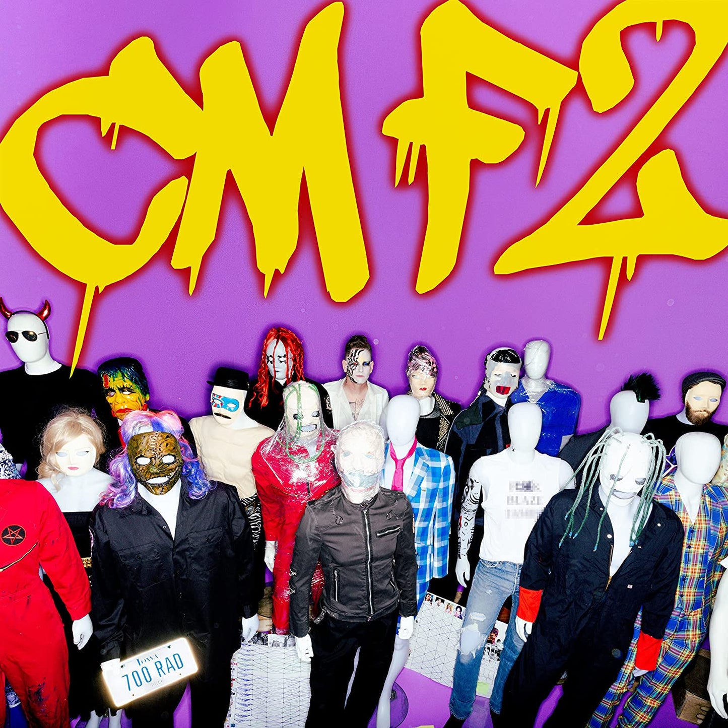 A group of mannequins with various masks and costumes on a purple background.